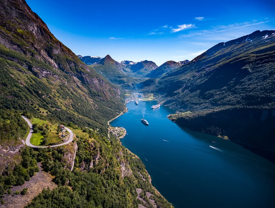 A cruise ship navigating a beautiful Norwegian Fjord